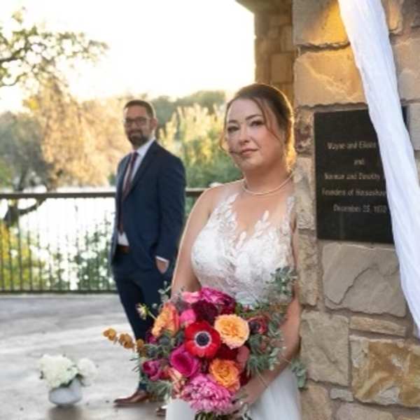 Bride holding a colorful bouquet of mixed flowers