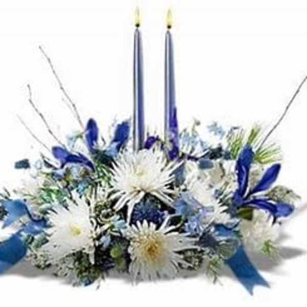Blue and white floral centerpiece with two tall candles
