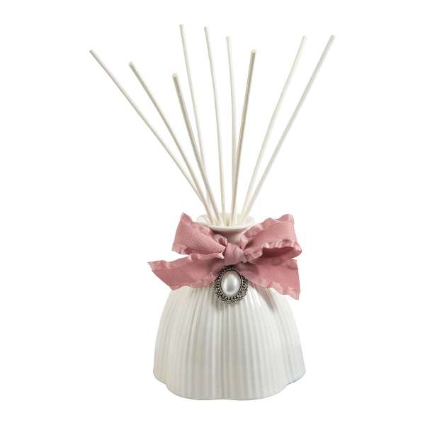 White ribbed diffuser bottle with pink ribbon and reed sticks