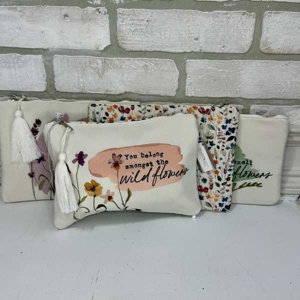 Floral zip pouches with tassels and printed wildflower designs