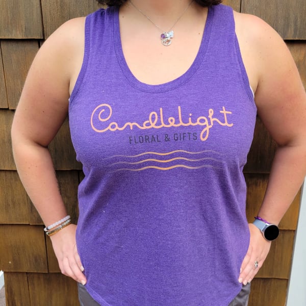 Person wearing a purple tank top with a floral shop logo