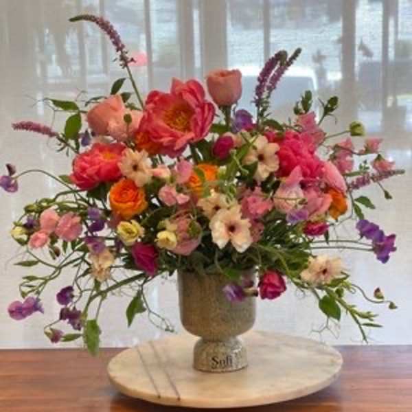 Colorful mixed flower arrangement in a pedestal vase