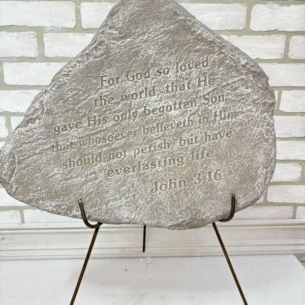 Engraved memorial stone on a metal stand with Bible verse text