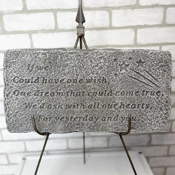 Stone plaque on a metal easel with an engraved quote and stars