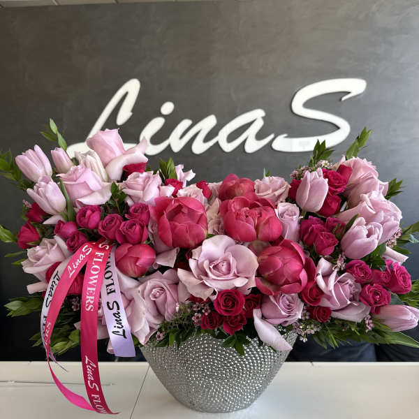 Pink and red rose bouquet in a silver textured vase