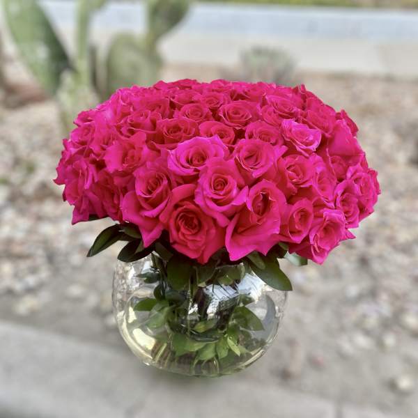 Bright pink rose bouquet in a clear glass vase