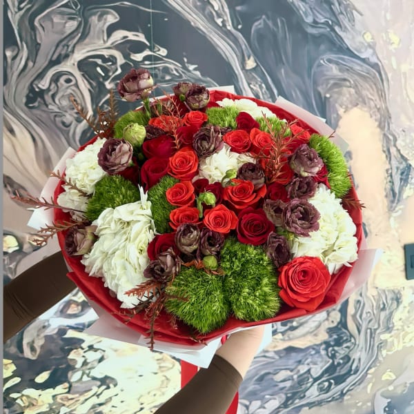 Bouquet of red and white roses with green pom-pom accents