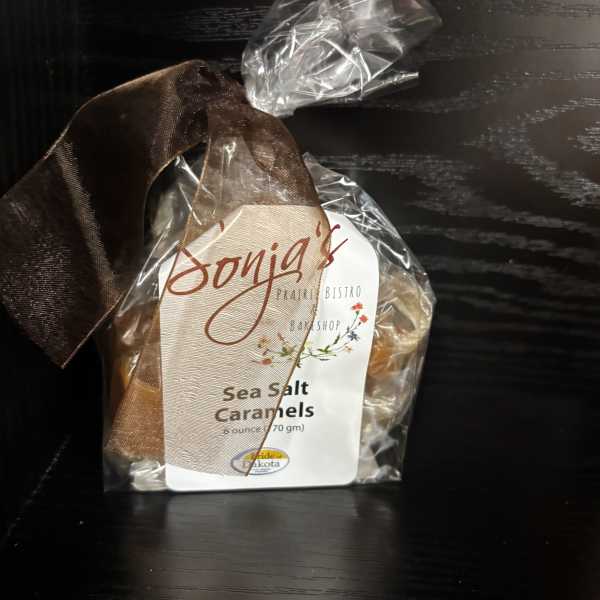 Wrapped bag of sea salt caramels with a brown ribbon