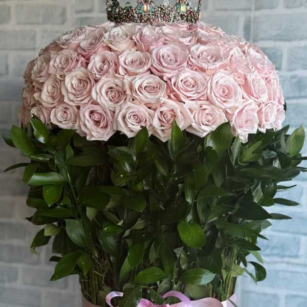 Large pink rose arrangement topped with a jeweled crown