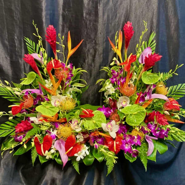 Tropical floral arrangement with red, orange, pink, and white blooms