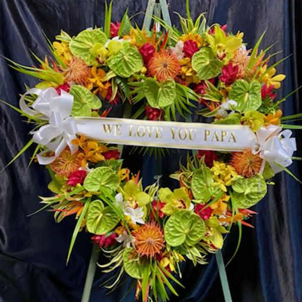 Heart-shaped floral wreath with a "We Love You Papa" ribbon