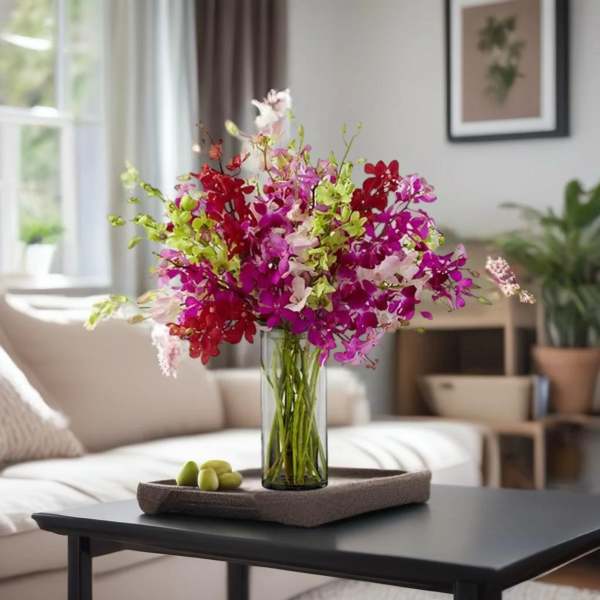 Colorful orchid bouquet in a clear glass vase on a tray