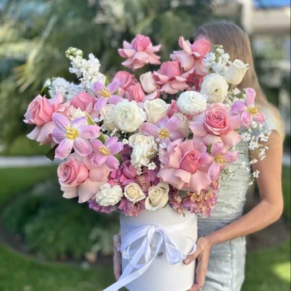 Large pink and white bouquet in a white hat box with ribbon