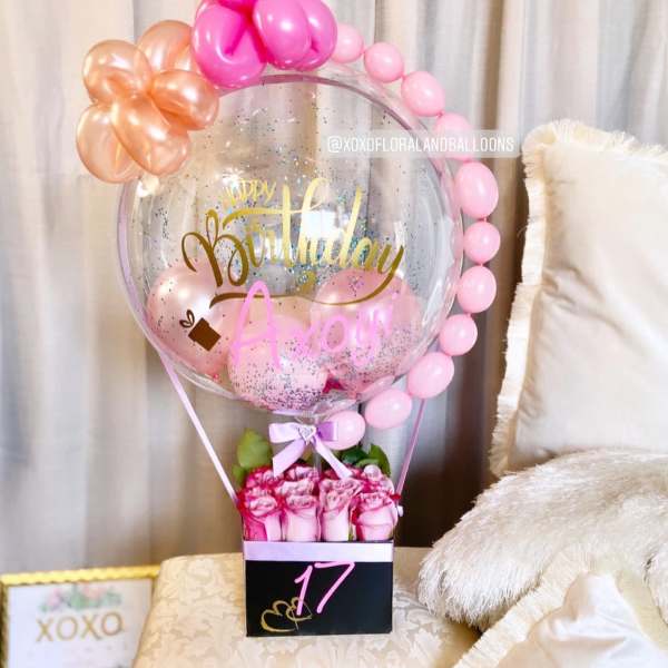 Pink rose bouquet with a birthday balloon display and a large clear balloon