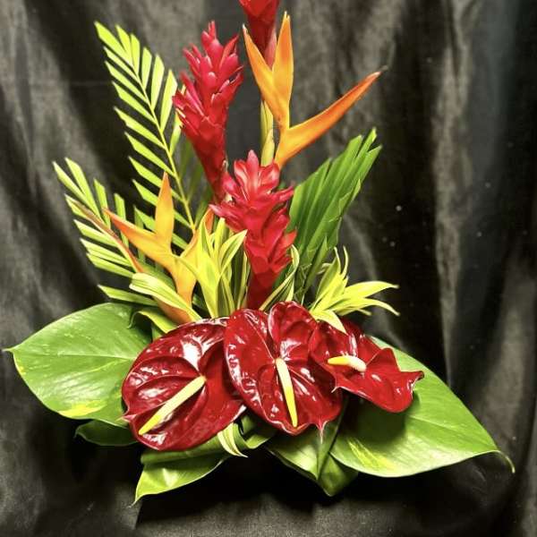 Tropical arrangement with red anthuriums and orange bird-of-paradise flowers