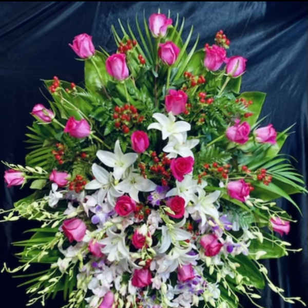 Large standing floral spray with pink roses and white lilies