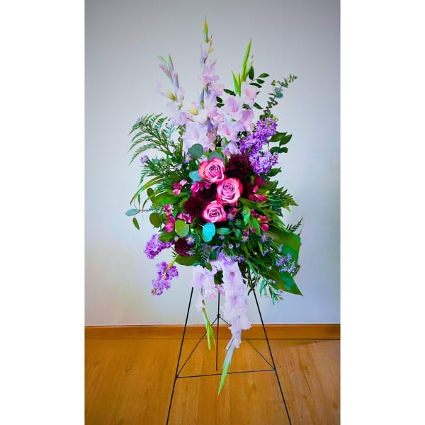 Tall floral spray with pink roses and lavender blooms on a stand