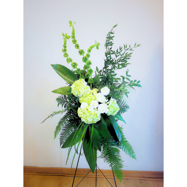 Tall floral standing arrangement with white and pale green blooms