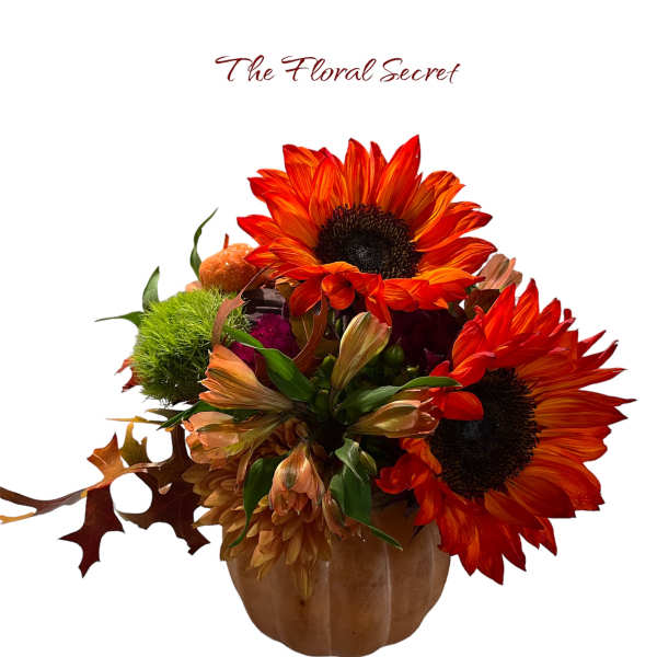 Orange sunflower arrangement in a pumpkin-shaped vase