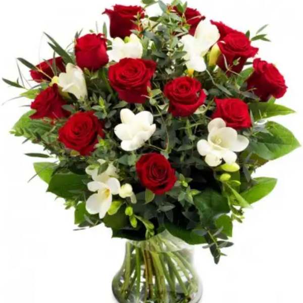 Bouquet of red roses and white orchids in a glass vase