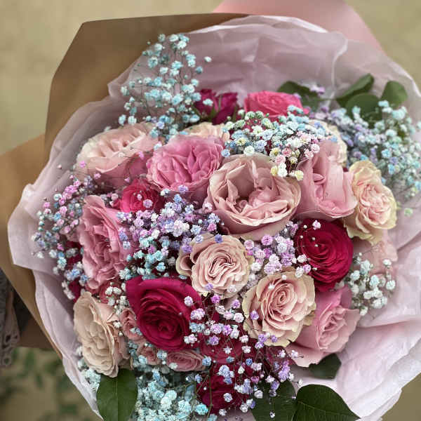 Bouquet of pink and red roses with pastel baby's breath