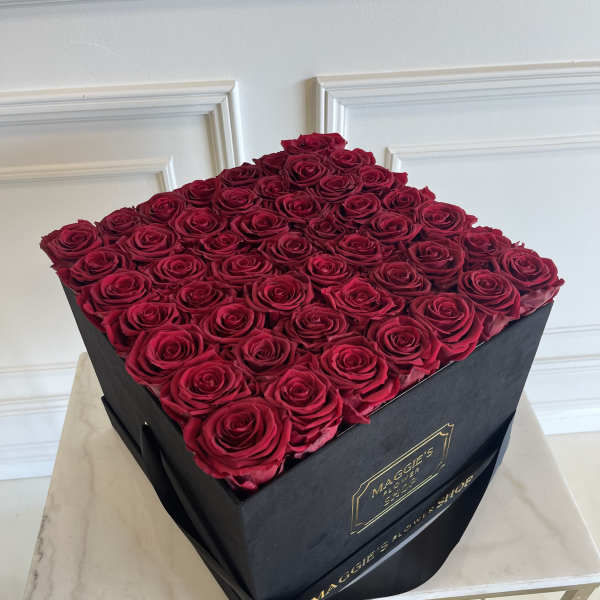 Square box filled with red roses