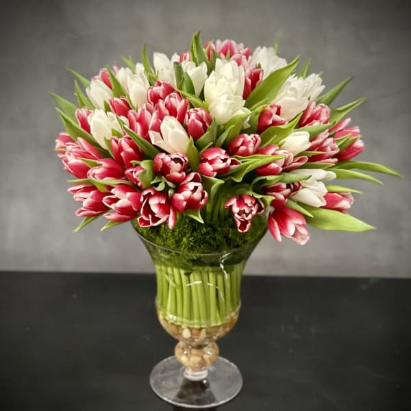 Bouquet of pink and white tulips in a glass vase