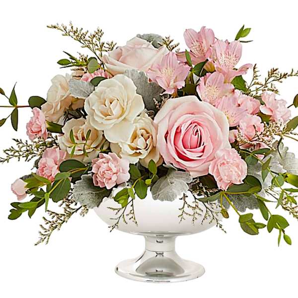 Pink and white floral arrangement in a white pedestal vase