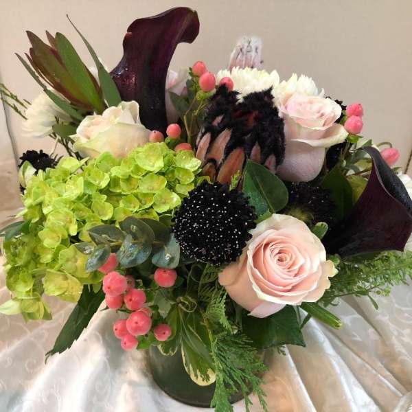 Bouquet with pale pink roses, green hydrangea, and dark calla lilies