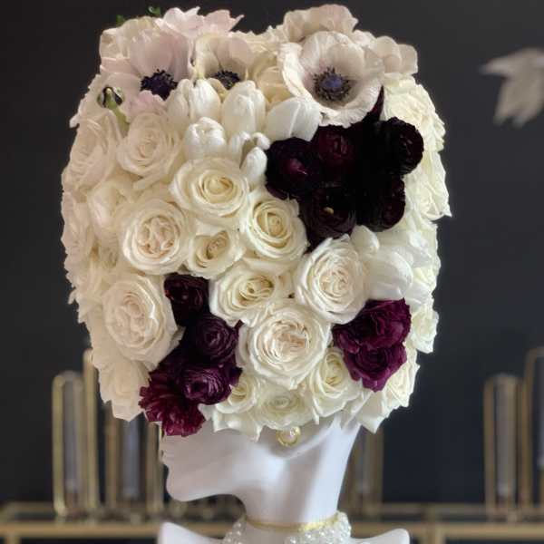 White and burgundy floral headpiece on a mannequin bust