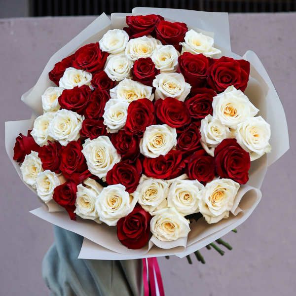Large bouquet of red and white roses wrapped in white paper