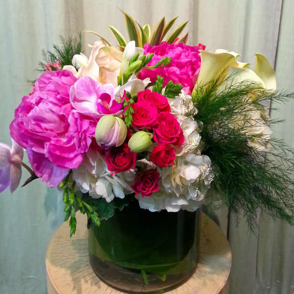 Pink and white mixed bouquet in a dark glass vase