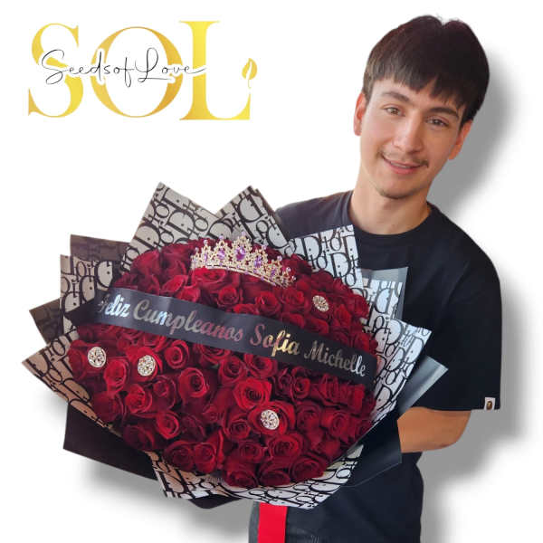 Man holding a large bouquet of red roses with a birthday ribbon