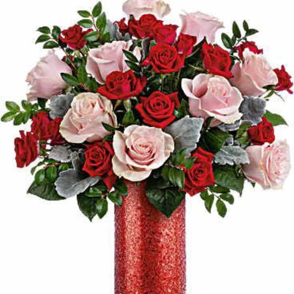 Bouquet of red and pale pink roses in a red vase