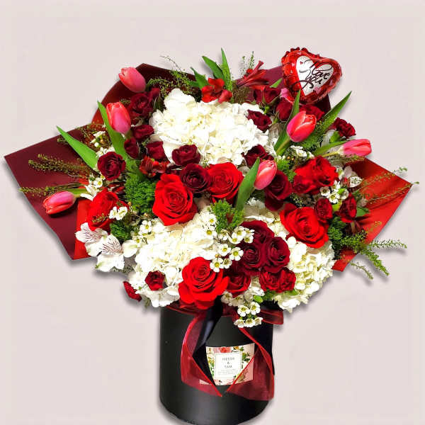 Red and white rose bouquet in a black box with a heart balloon