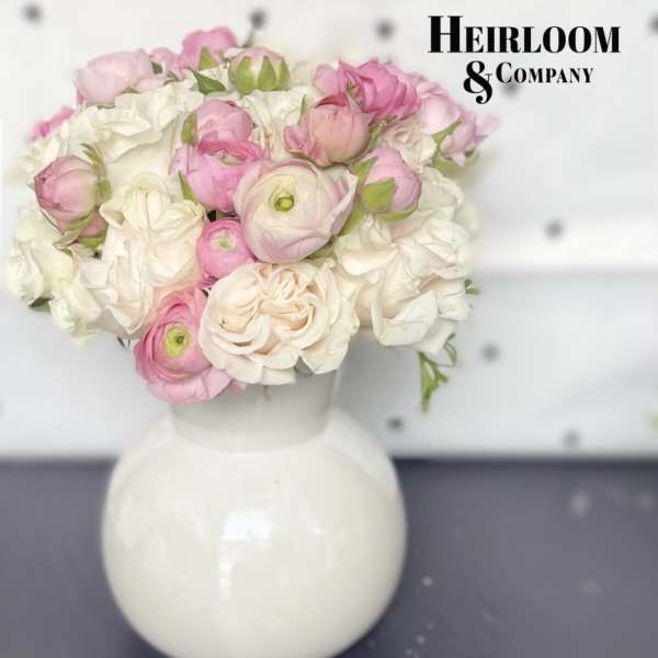 Pink and white flower bouquet in a white vase