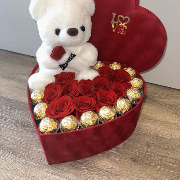 Beautiful velvet box with a teddy bear, Ferrero Rocher chocolates encased in acrylic, and red roses.