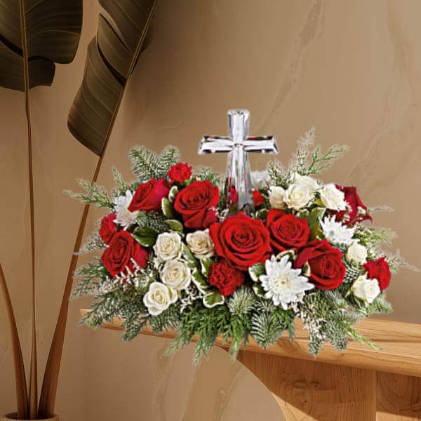 Red and white rose arrangement with a clear cross centerpiece