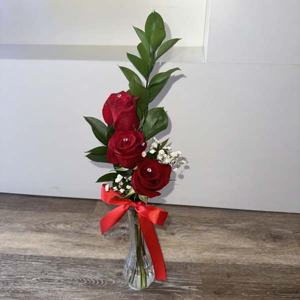 Lovely detail of 3 roses in a glass vase