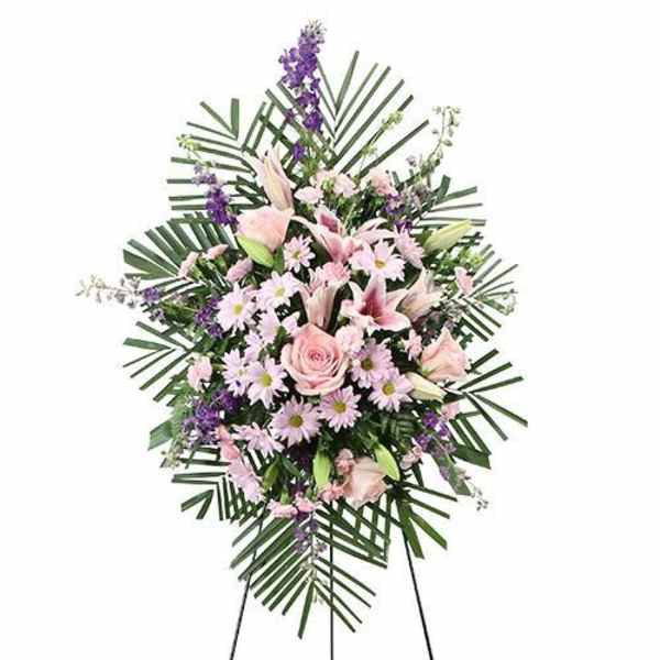 Standing floral spray with pink lilies, roses, and purple accents
