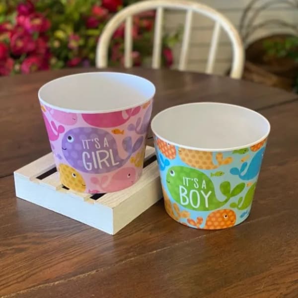 Two baby shower paper cups reading It's a Girl and It's a Boy