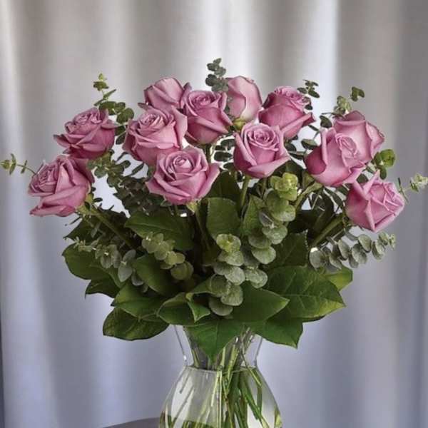Pink roses arranged in a clear glass vase