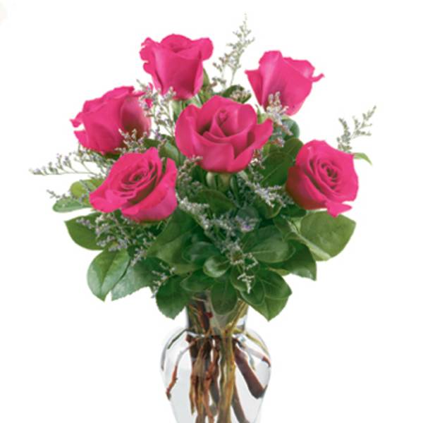 Pink roses arranged in a clear glass vase
