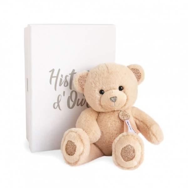Plush teddy bear in front of a white book-shaped box