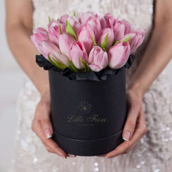 Pink tulips arranged in a black round box