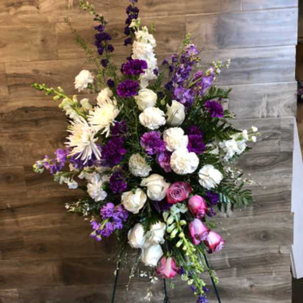 Tall floral spray with white, pink, and purple blooms on a stand