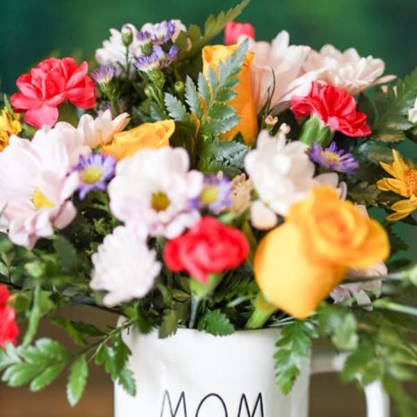 Mixed bouquet in a white mug labeled MOM