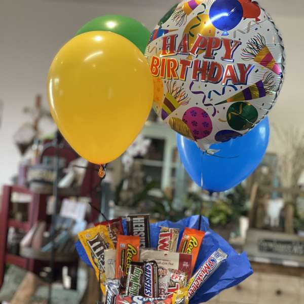 Birthday balloon bouquet with candy bars in a black container