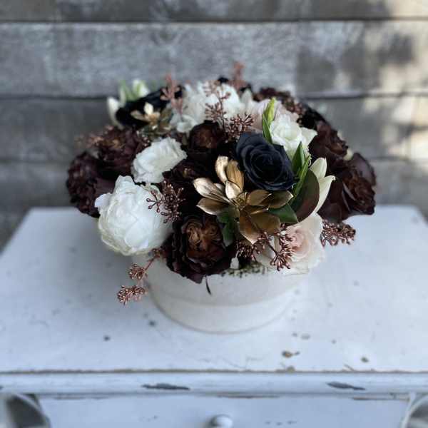 Round bouquet of white, blush, and dark roses in a white box