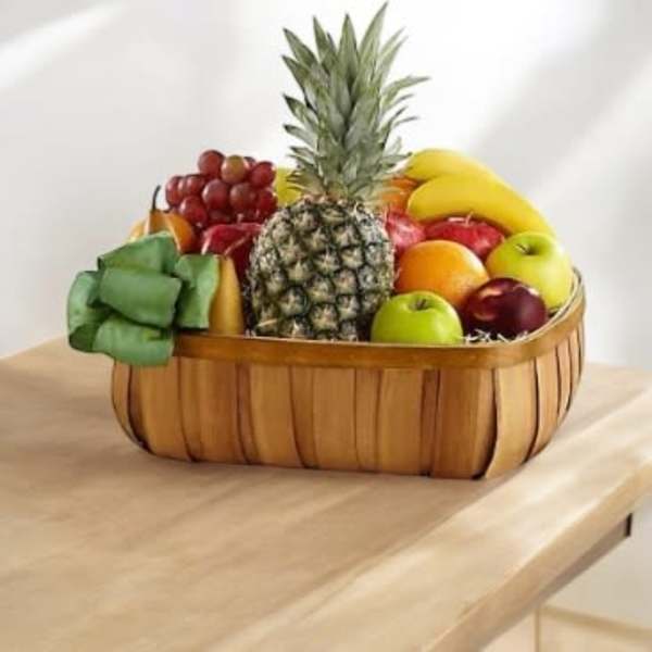 Fruit basket with pineapple, bananas, grapes, apples, and oranges